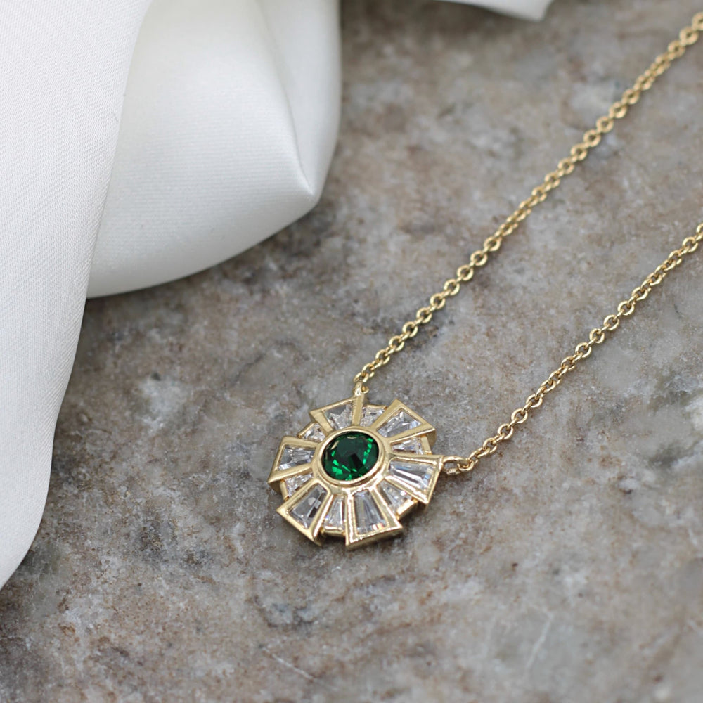 Gold Circle Pendent with a Emerald Centre Stone and Clear CZ stones