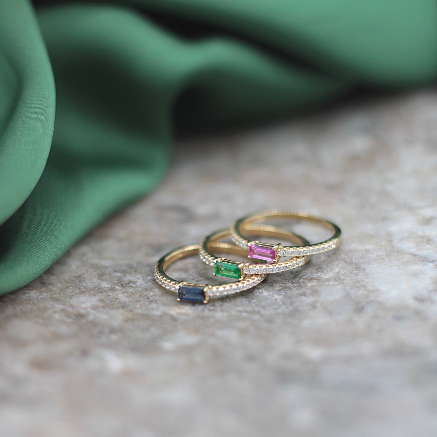 Stackable Gold Eternity Ring with Clear Stones and a Baguette Sapphire Stone